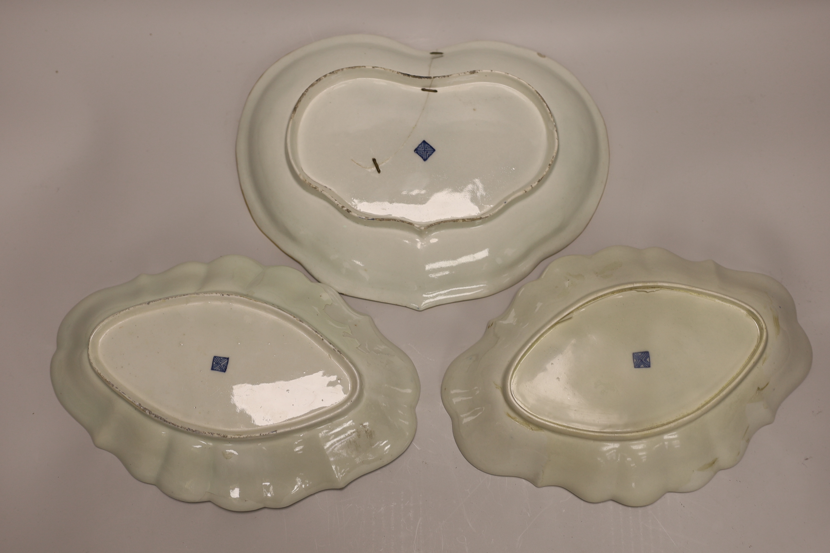 A pair of Worcester oval lobed dishes painted with flowers on a blue scale ground and a matching heart shaped dish-28cm wide x 21cm high